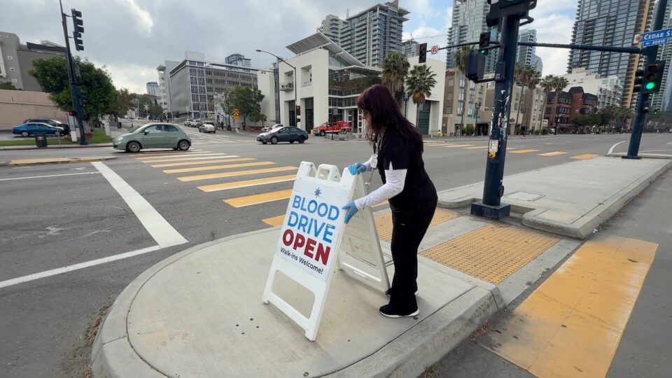 Person puts out Blood Drive sign outside the County Administration Center