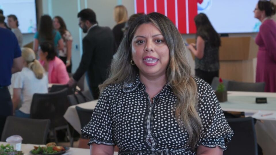 person stands in front of busy room
