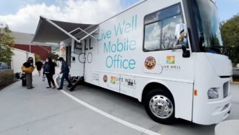 Mobile Office bus with people out front