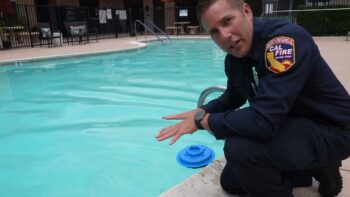 CAL FIRE employee squats down next to pool