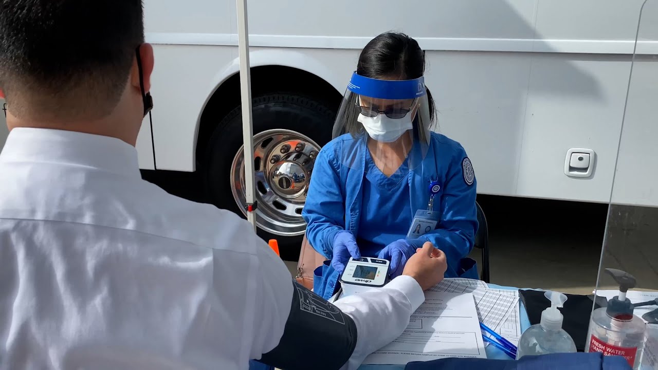 a nurse checking a man's blood pressure