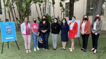 group of woman stand outside County Administration Center with masks on