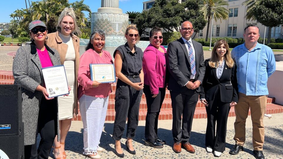 group stand in front of a fountain outside