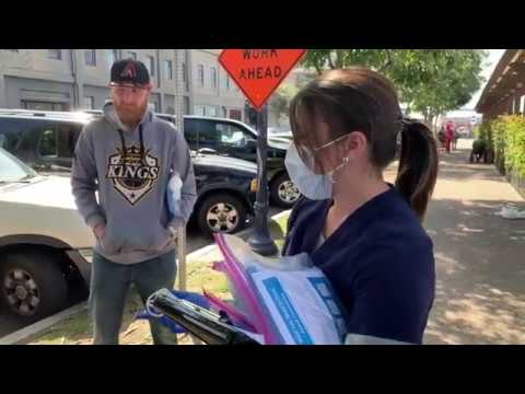 nurse handing out hygiene kits