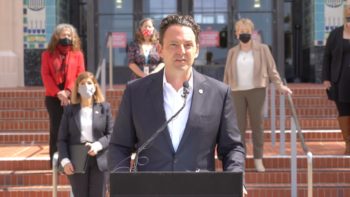 Chair Fletcher speaks at a podium in front of County Administration Center