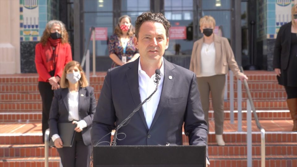 Chair Fletcher speaks at a podium in front of County Administration Center