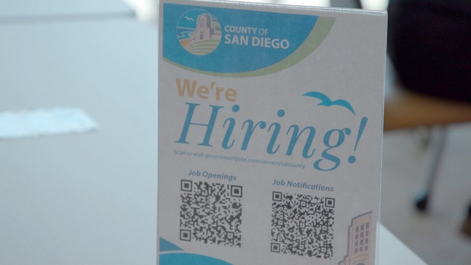 "We're Hiring Sign" on table