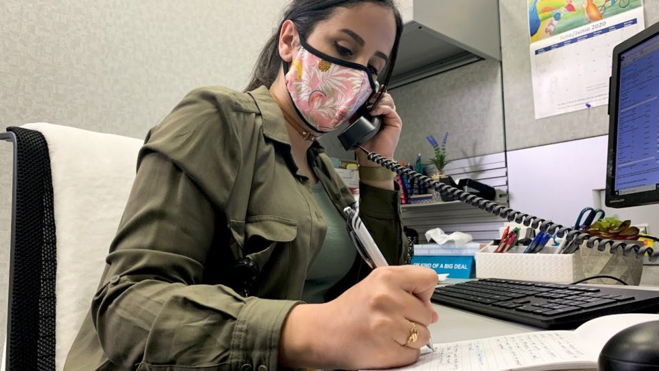 a woman talking on the phone and taking notes