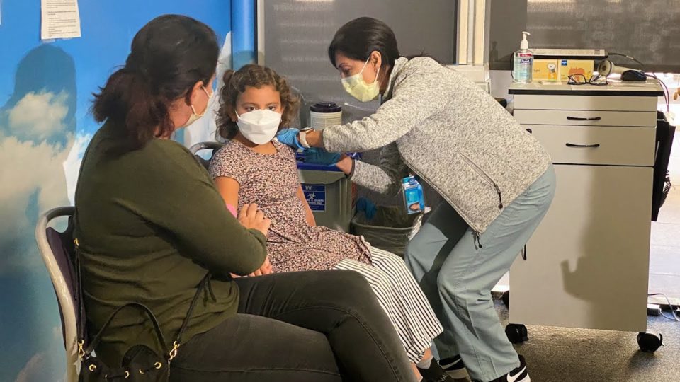 a young girl gets a vaccine