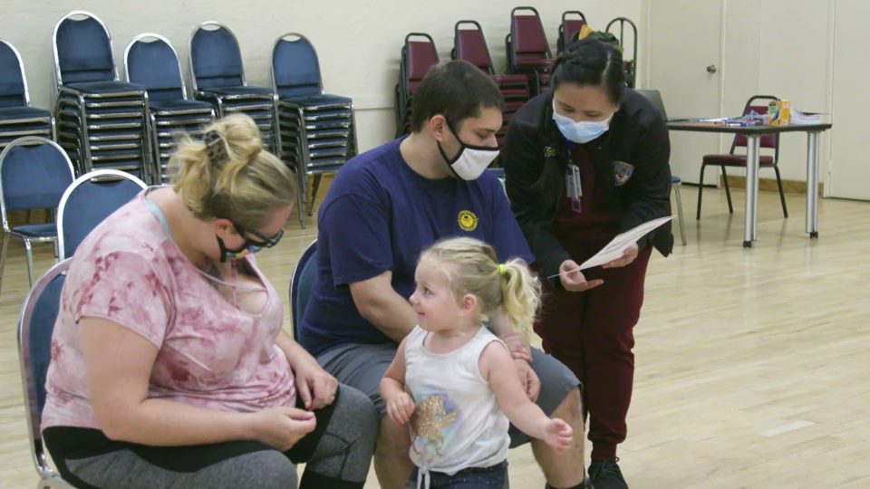 family waits to get their vaccines