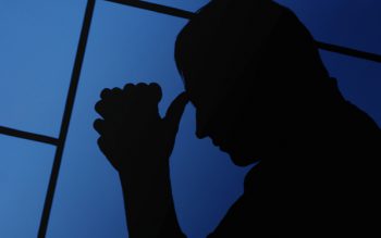 man with head in hands