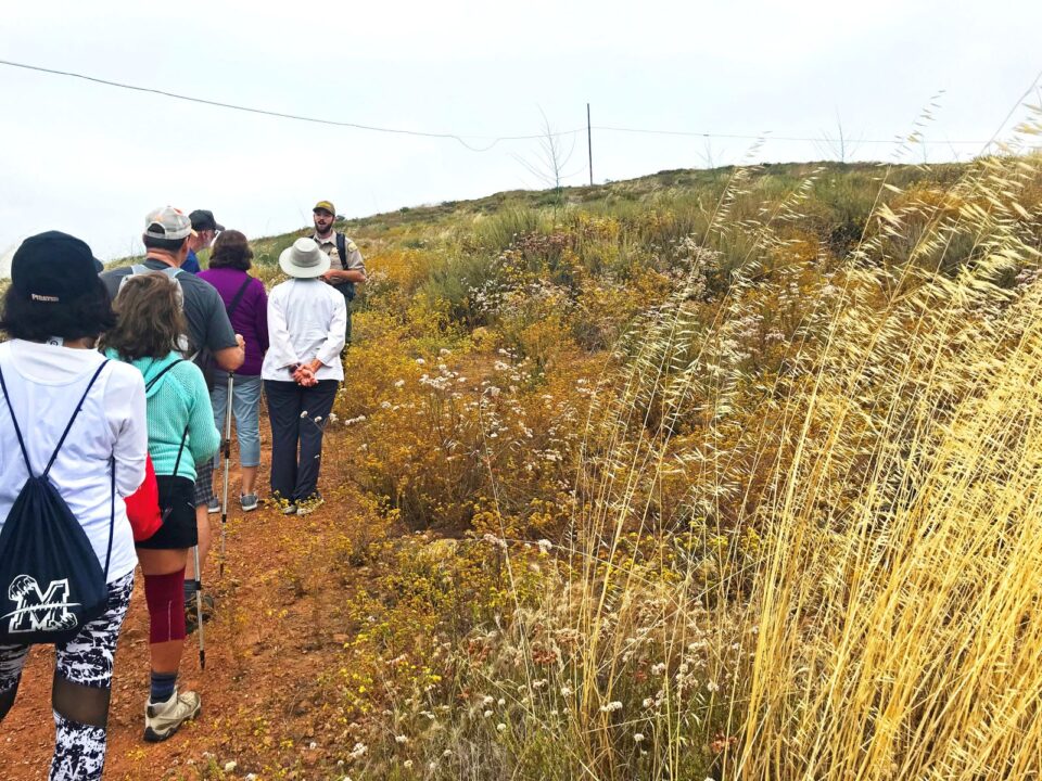 Hikers listening to guide