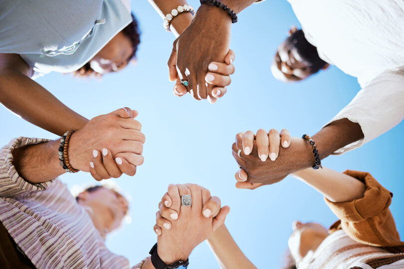 People holding hands as seen from below