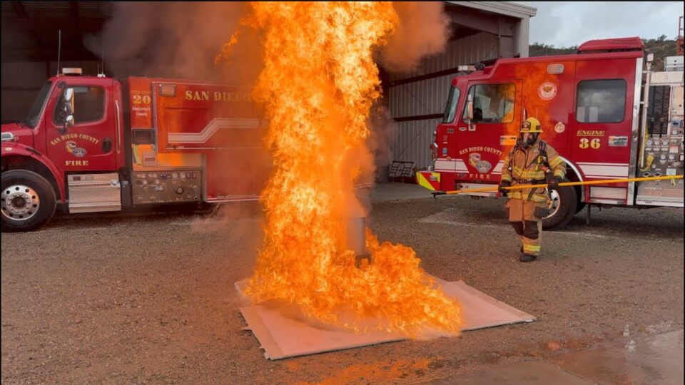 large fire of turkey fryer in front of fire engines