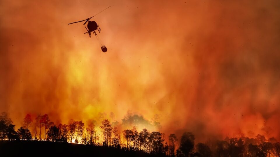 helicopter flying over fire