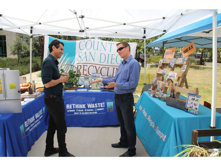 Two people talking at Earth Day Fair