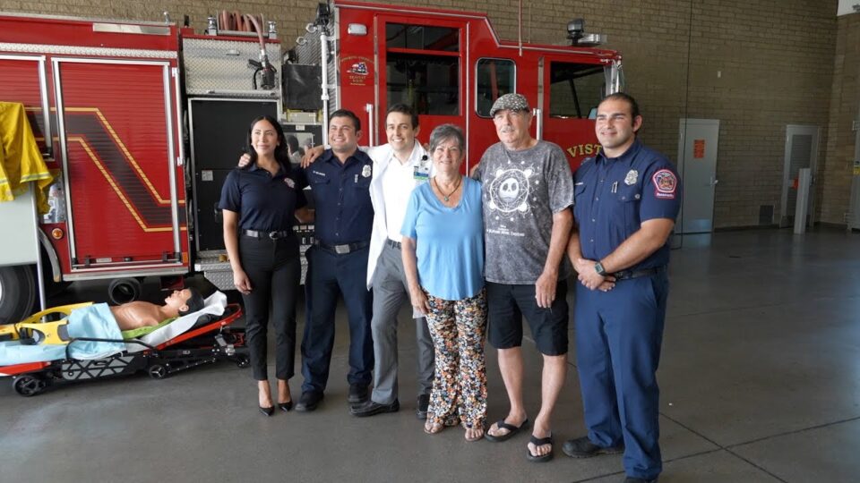 group stands in front of firetruck