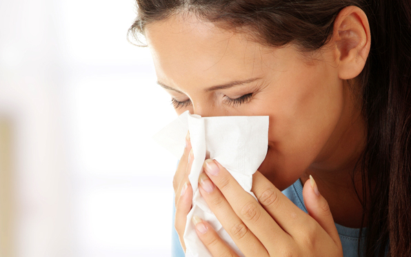woman blowing her nose