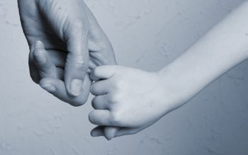 adult and child holding hands