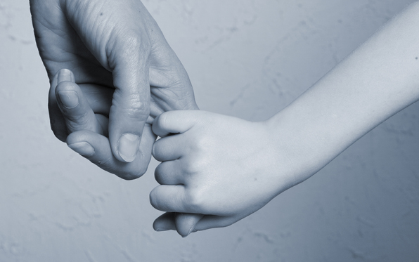 adult and child holding hands