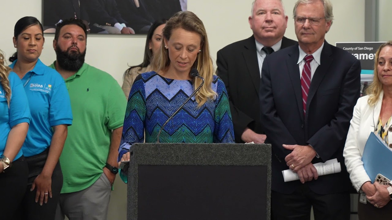 Terra Lawson-Remer speaks at a podium with others behind her