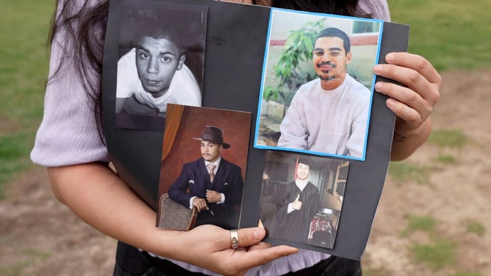 person holding photos of loved one