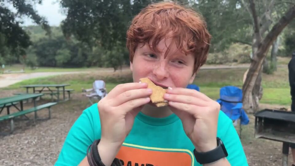 person eating s'more in park