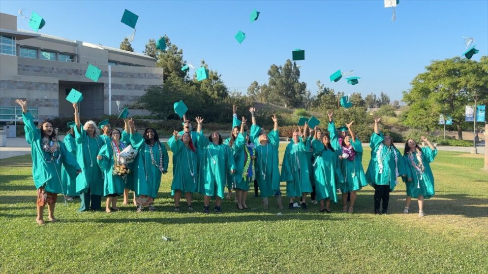 graduates throw caps in the air