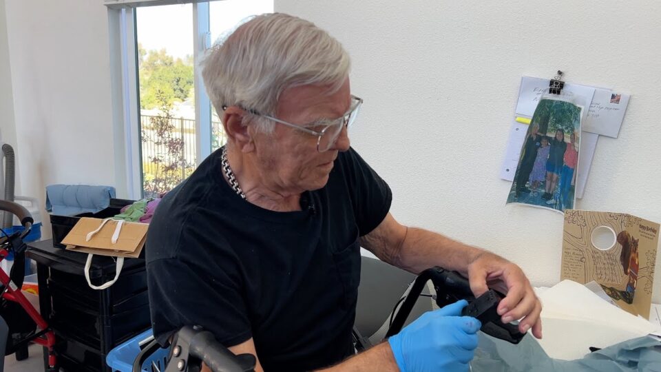 person holds small device in hand