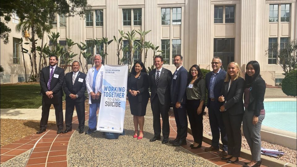 group stands outside the County Administration Center