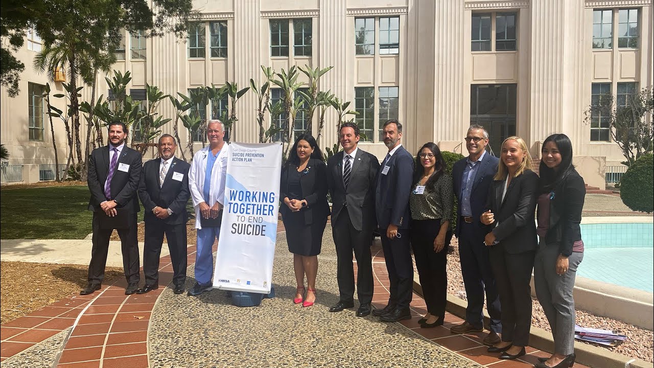 group stands outside the County Administration Center