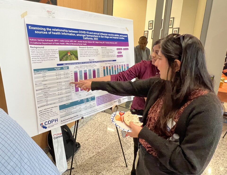 people point at a poster with flu data