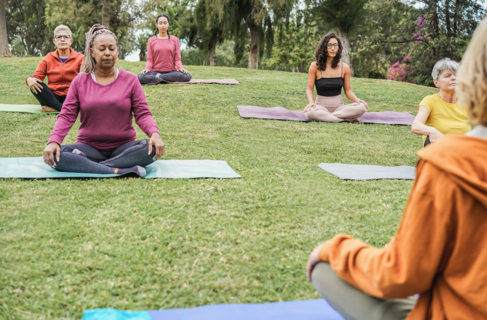 People doing yoga in the park