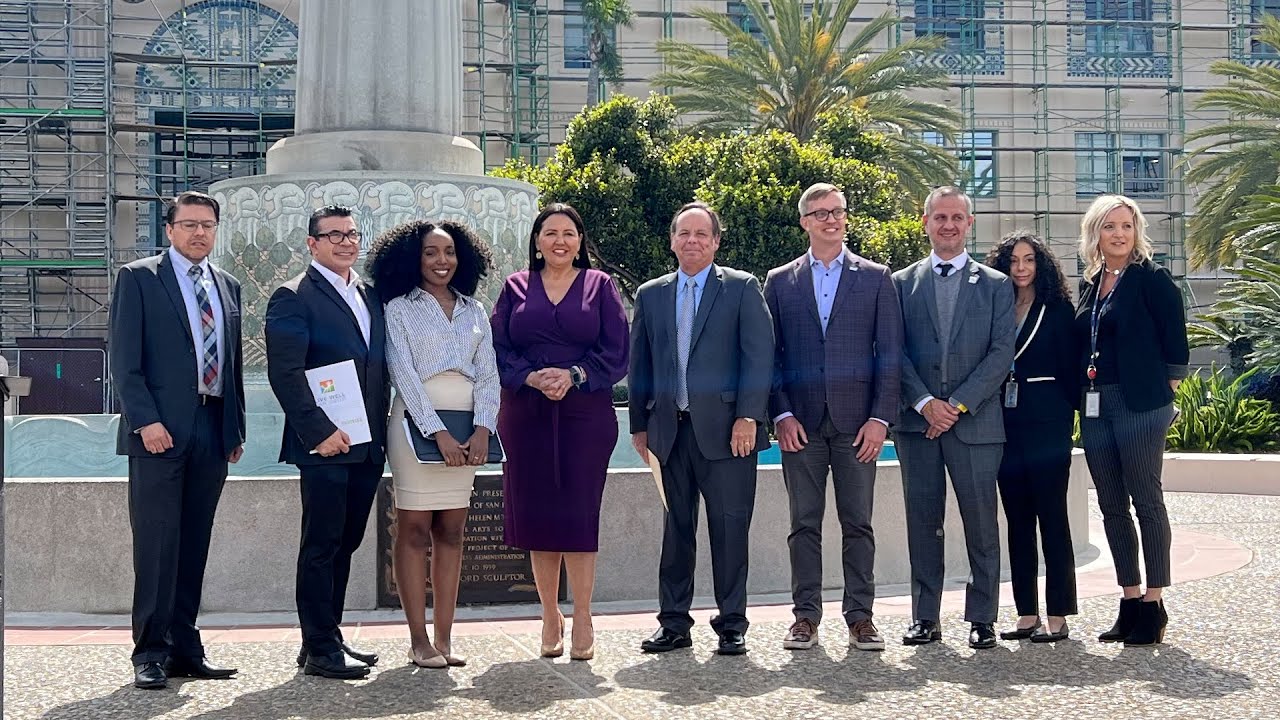 group stands in front of fountain outside the County Administration Center