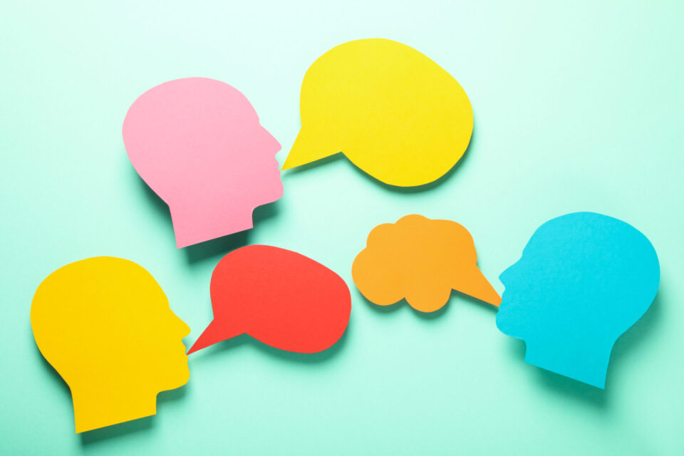 paper heads with speech bubbles