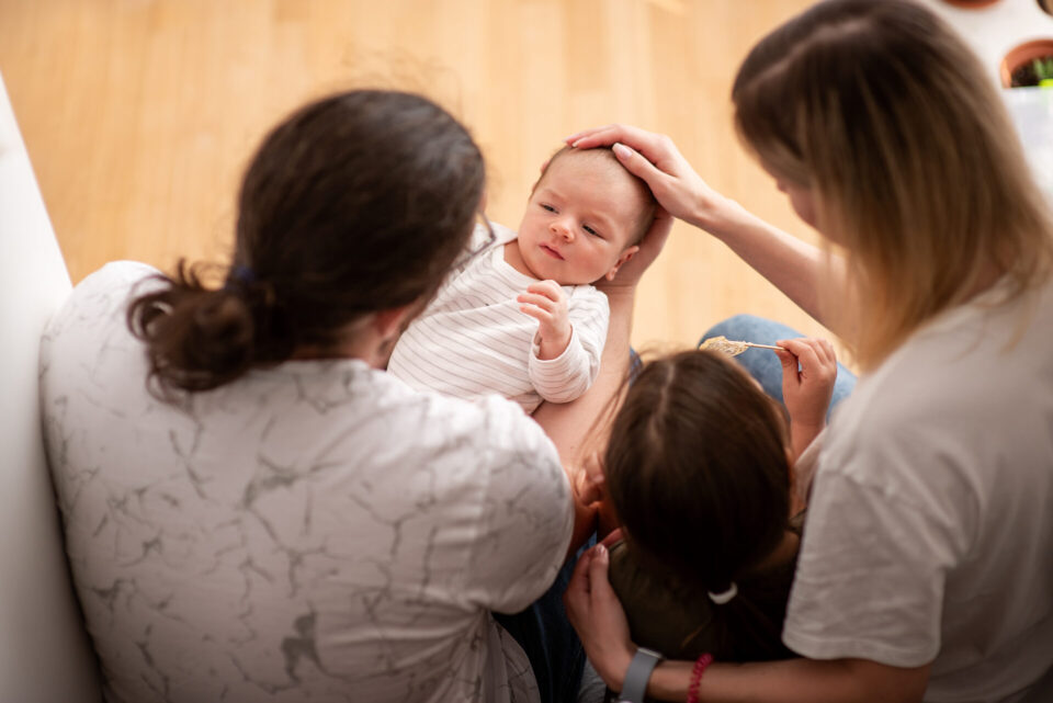 Family holds newborn baby
