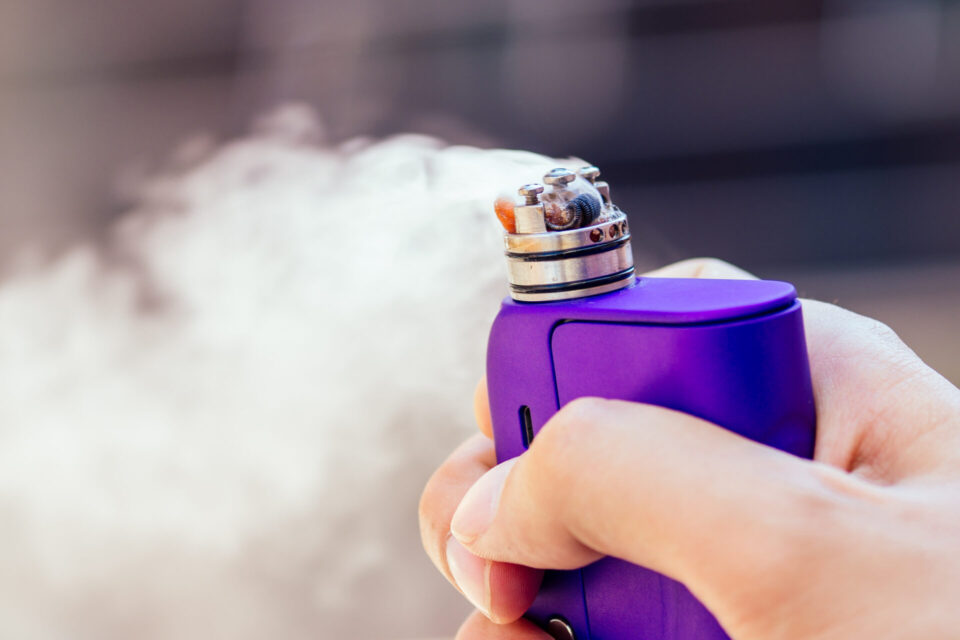 purple vape in a man's hand