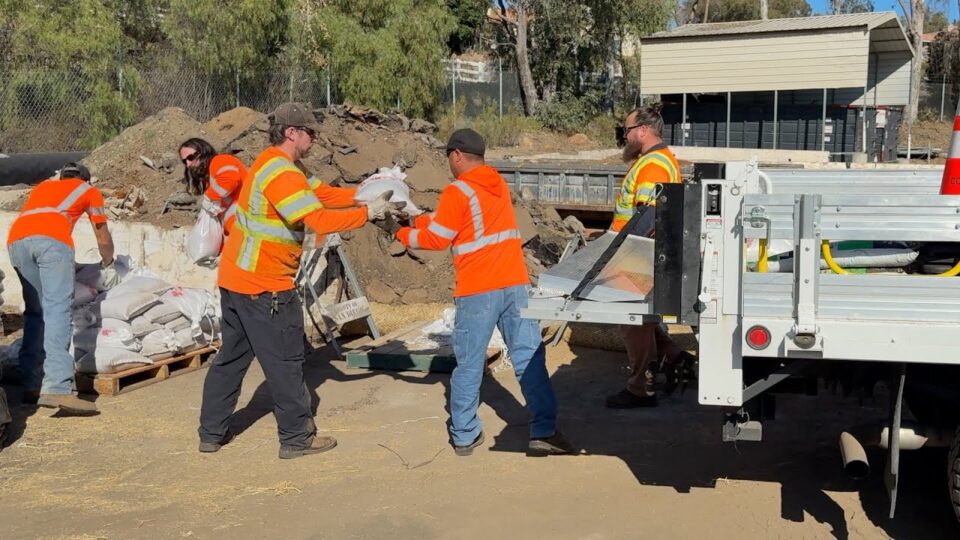 county workers loading sandbags