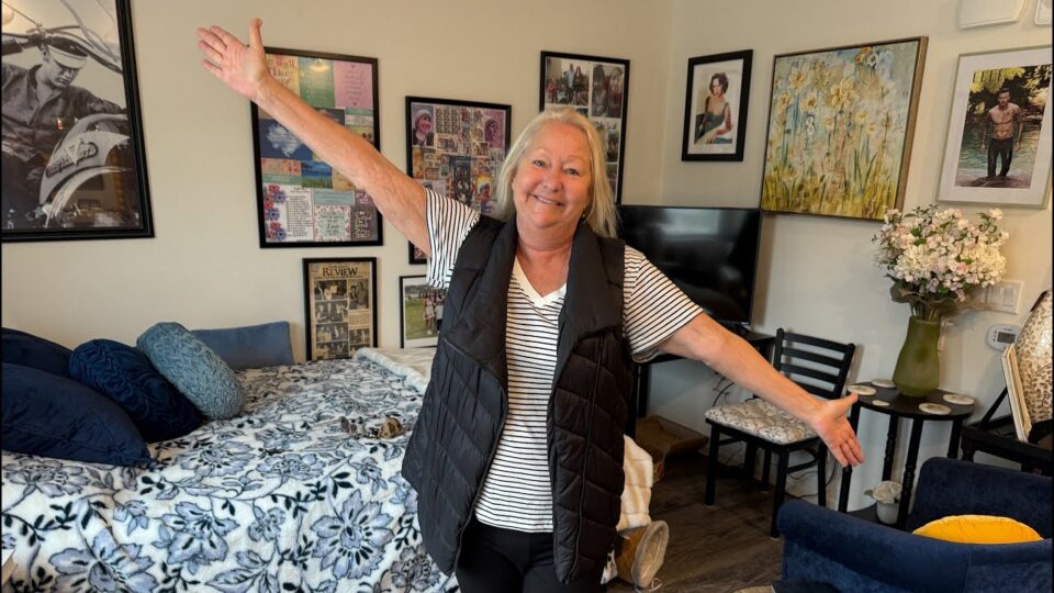 person outstretches arm in living space