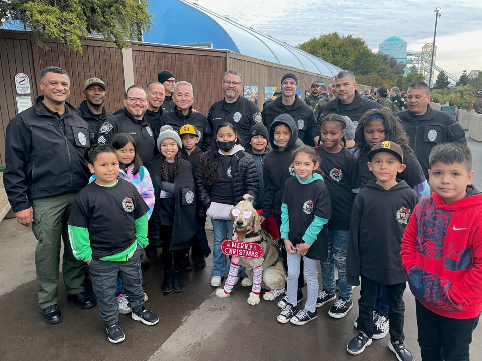 DA Investigators pose with kids at event