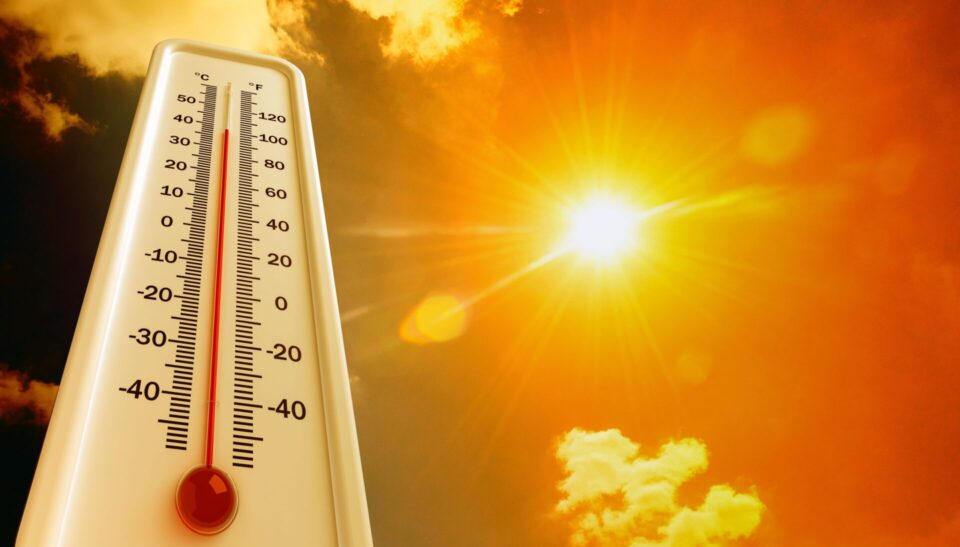 A thermometer with a blazing sun.