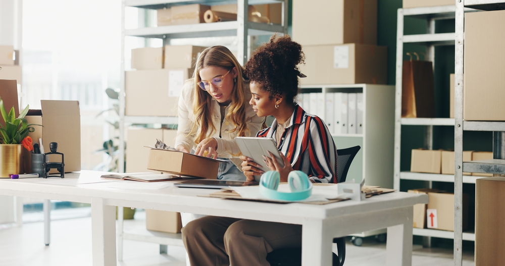 woman helping other woman at small business