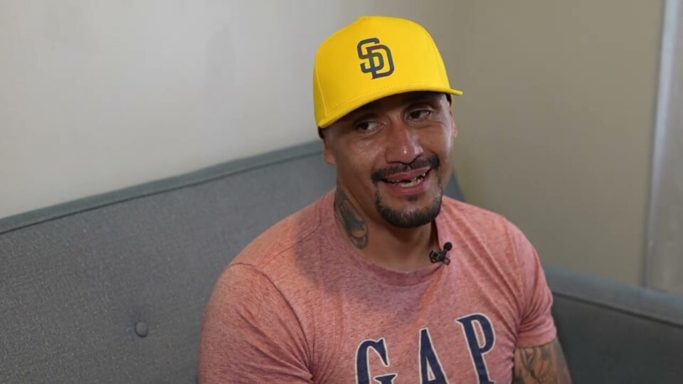 man wearing hat sits on sofa