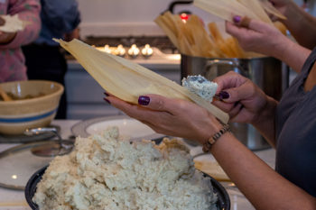 several people preparing food in a kitchen