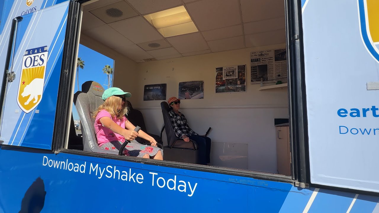 two people inside a van set up living space