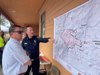 Capt. Thomas Shoots points at a map