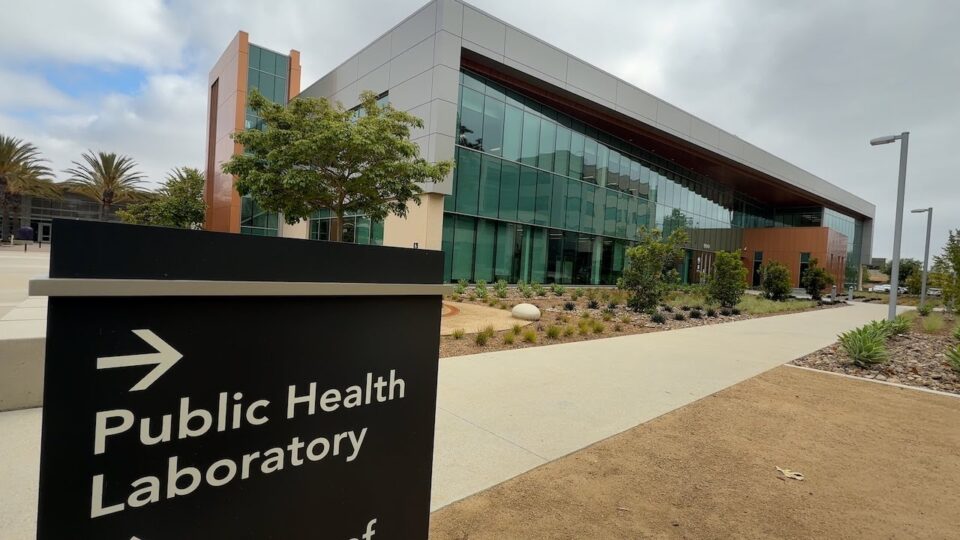 exterior of the public health lab with directional sign