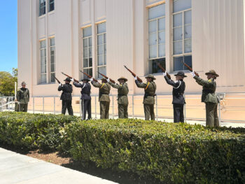 Three-volley salute team pointing rifles up