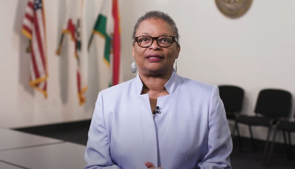 Dr. Wilma Wooten stands in an empty conference room