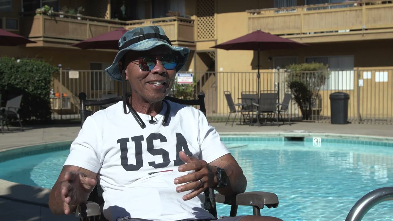 Man sits in chair by pool